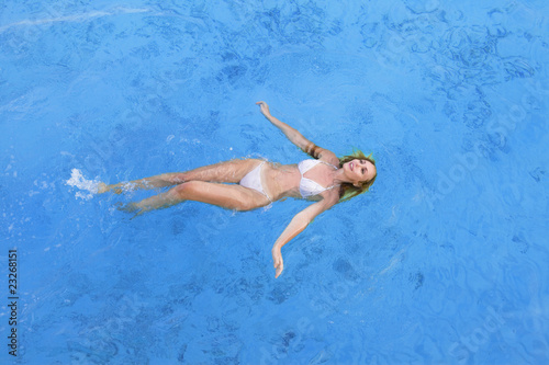 Young woman smiles, swiming in ocean, Maldives