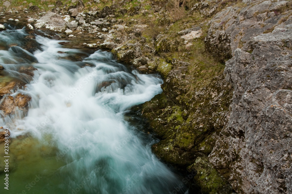 Naklejka premium Waterfall with stones in wild nature
