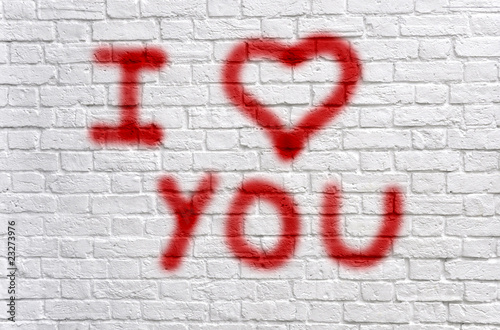 Love graffiti on a white brick wall