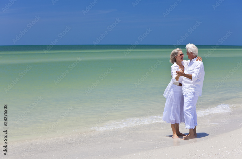 Happy Senior Couple Dancing Holding Hands on Tropical Beach Happy Senior Couple Dancing Holding Hands on Tropical Beach