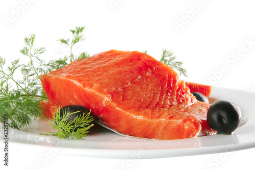 fresh smoked salmon on white plate with olives