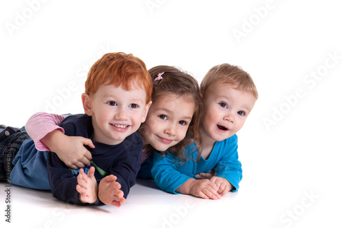 Three happy kids on floor together