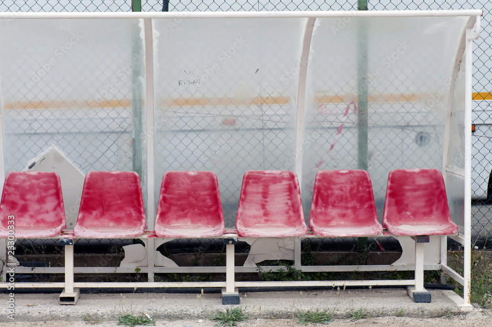 Obraz premium Old and damaged bench on a public football pitch