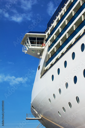 Luxury white cruise ship on a blue sky