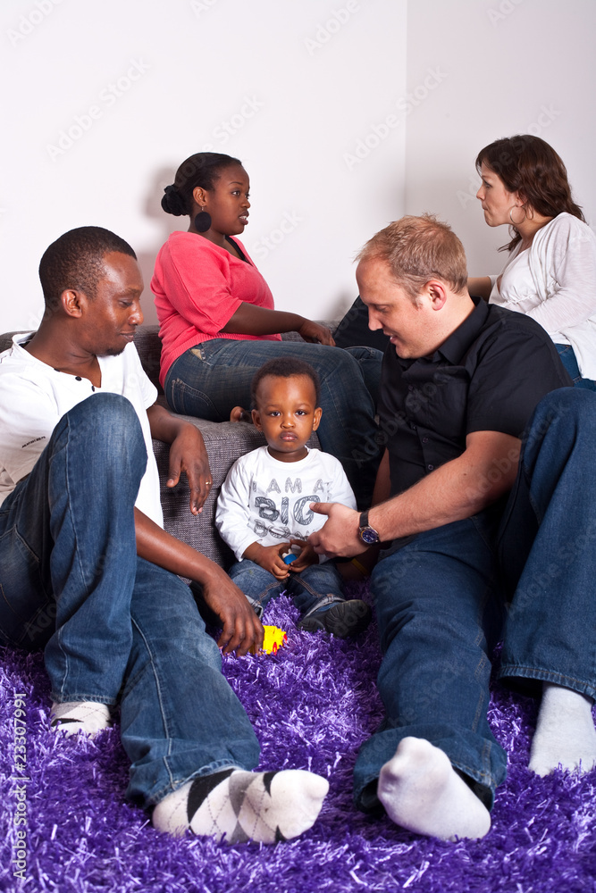 Young group of multiracial friends - two young families enjoying Young group of multiracial friends - two young families enjoying