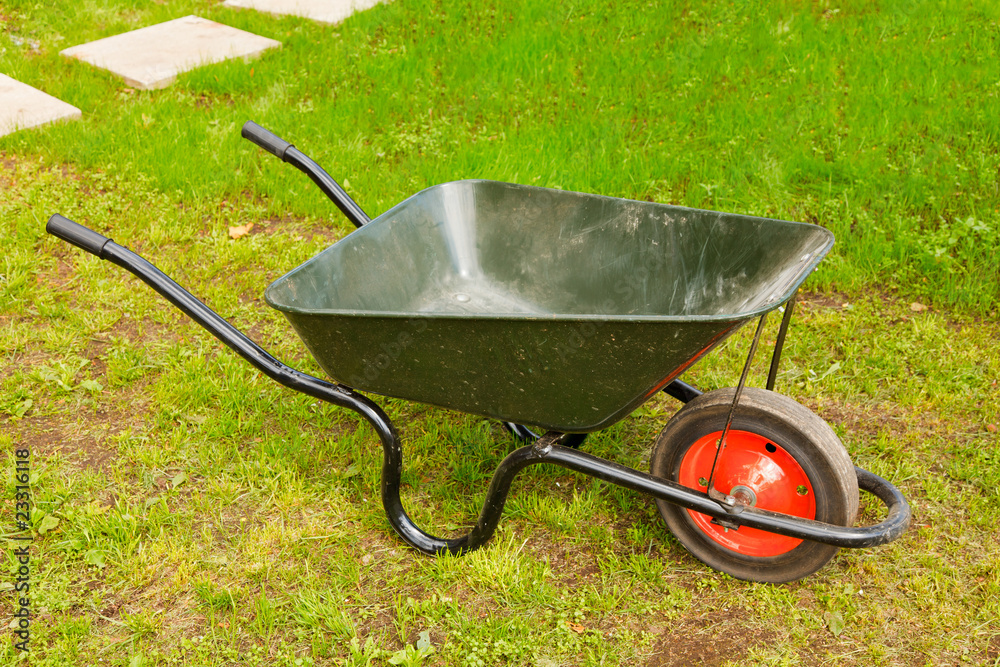 Green lawn with the green wheelbarrow Green lawn with the green wheelbarrow