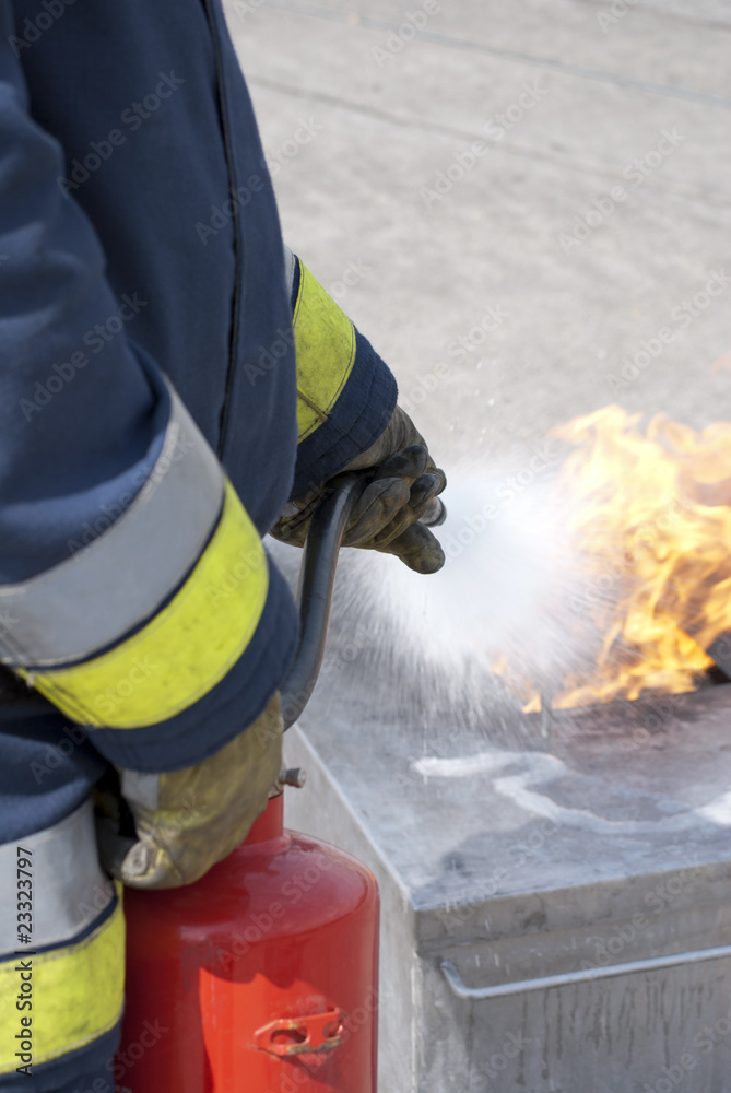 Firefighter using fire extinguisher