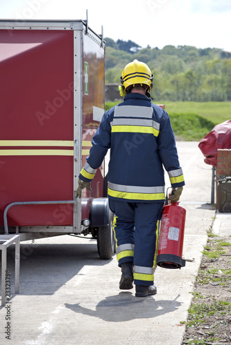 Firefighter carrying fire extinguisher