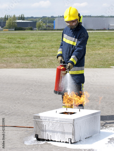 Fire fighter using extinguisher