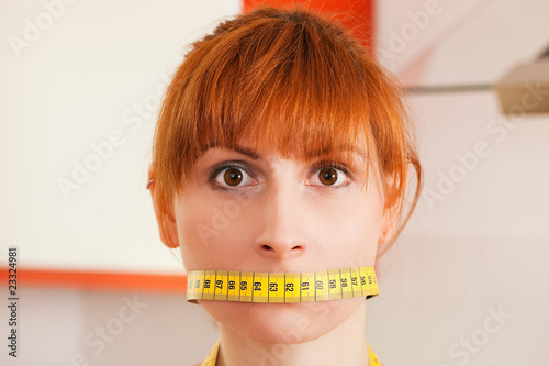 Woman gagged by a tape measure photo