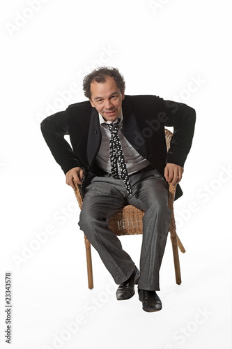 Mature man greeting you standed from chair