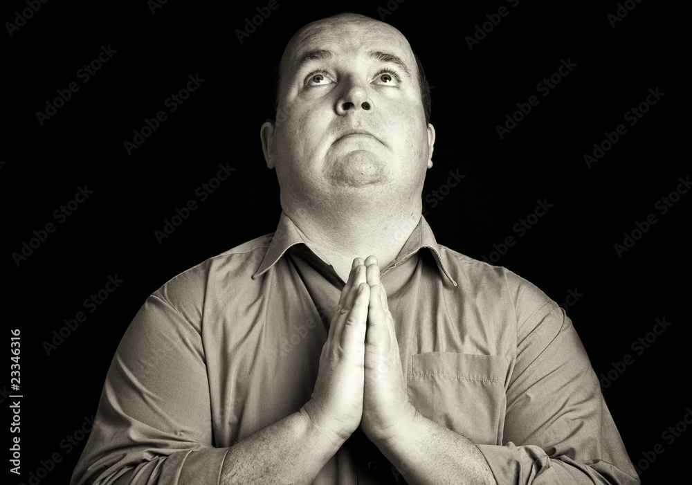 Fototapeta premium dark black and white overweight male praying