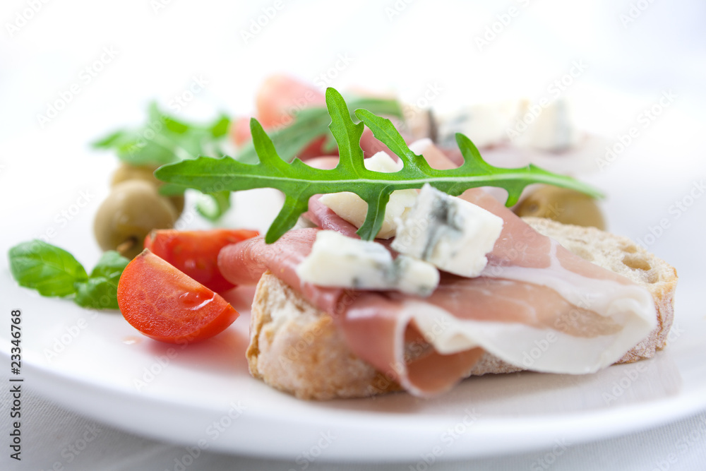 Canapes with prosciutto crudo and gorgonzola