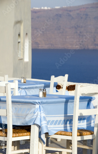 classic Greek island restaurant furniture with view of the volca photo