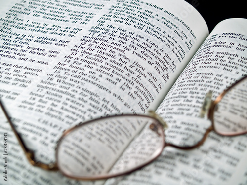 The Bible opened to the Book of Proverbs with Glasses photo