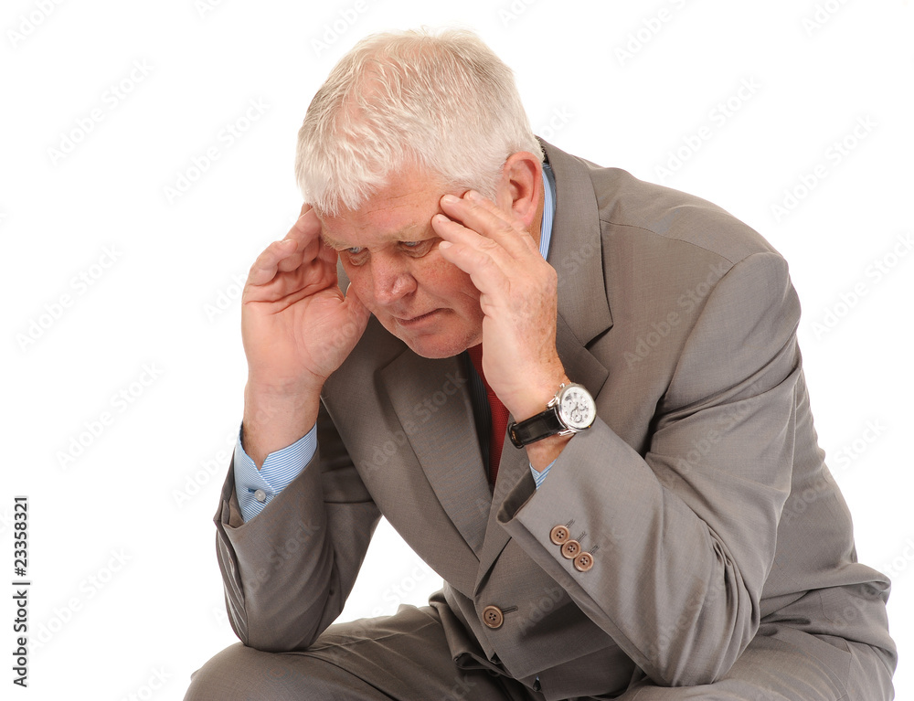 Depressed mature businessman holding head Depressed mature businessman holding head