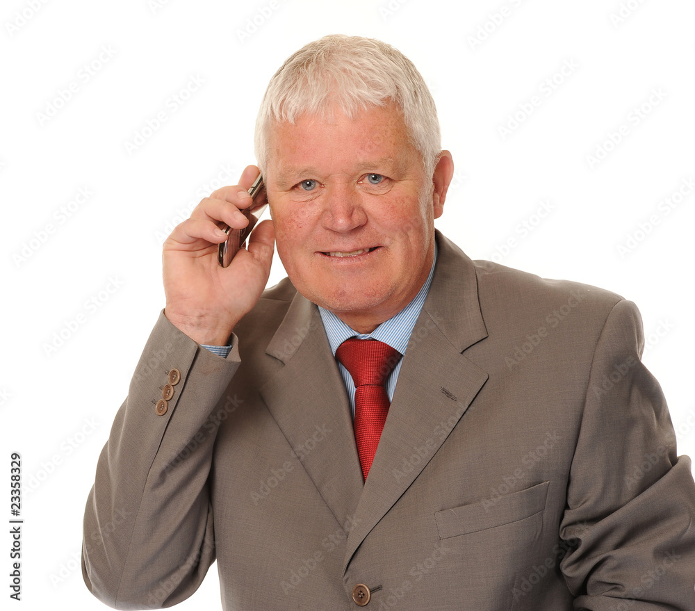 Successful mature businessman using phone