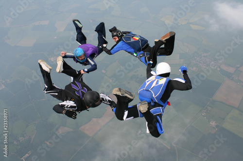 Four skydivers form a circle while in freefall