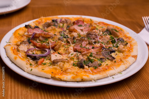 The pizza with salami and onion.