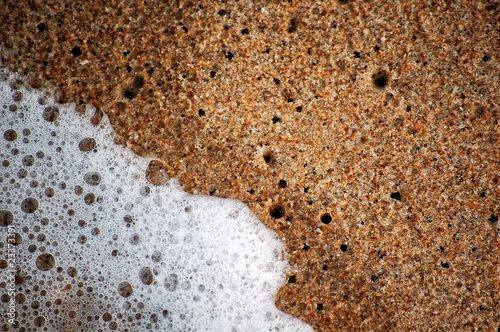 Texture of wet sand and ocean wave