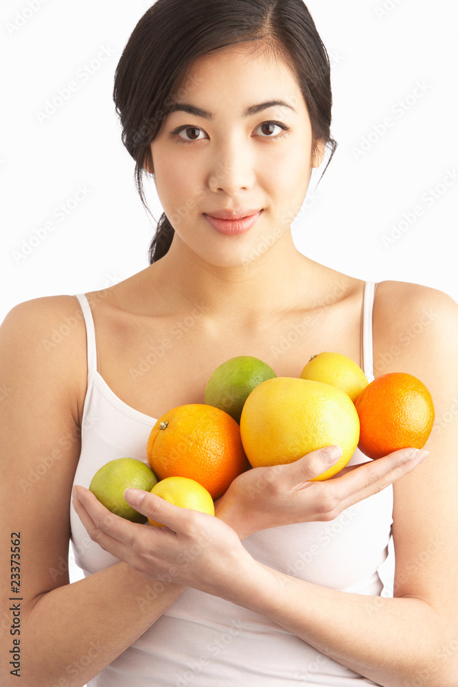 Young Woman Holding Citrus Fruit In Studio Young Woman Holding Citrus Fruit In Studio