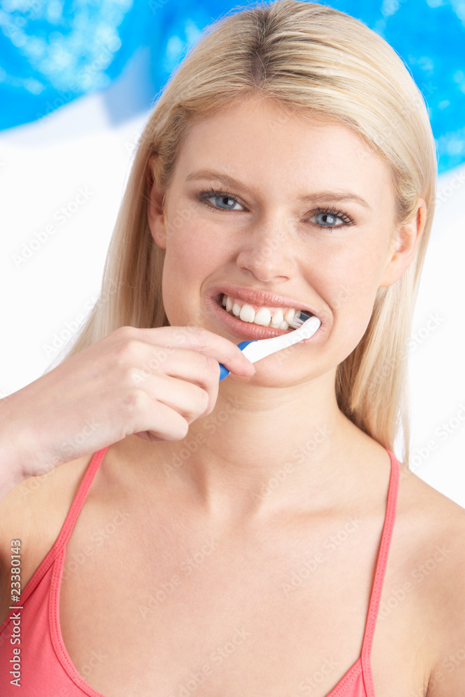 Young Woman Brushing Teeth In Studio Young Woman Brushing Teeth In Studio