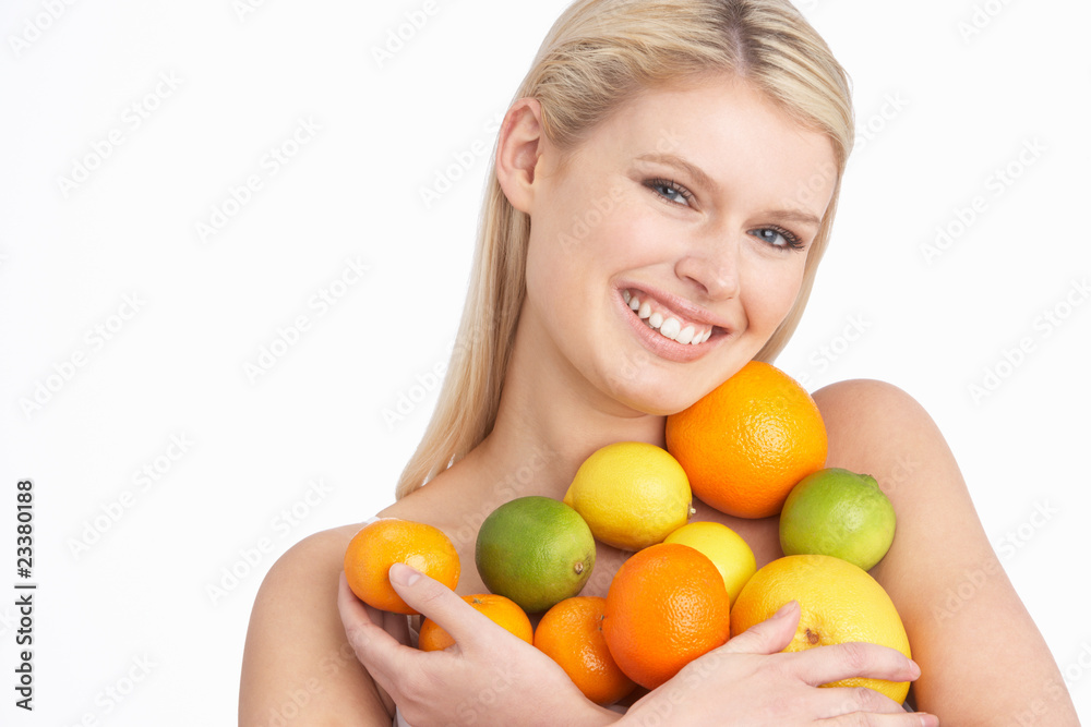 Young Woman Holding Citrus Fruit In Studio Young Woman Holding Citrus Fruit In Studio