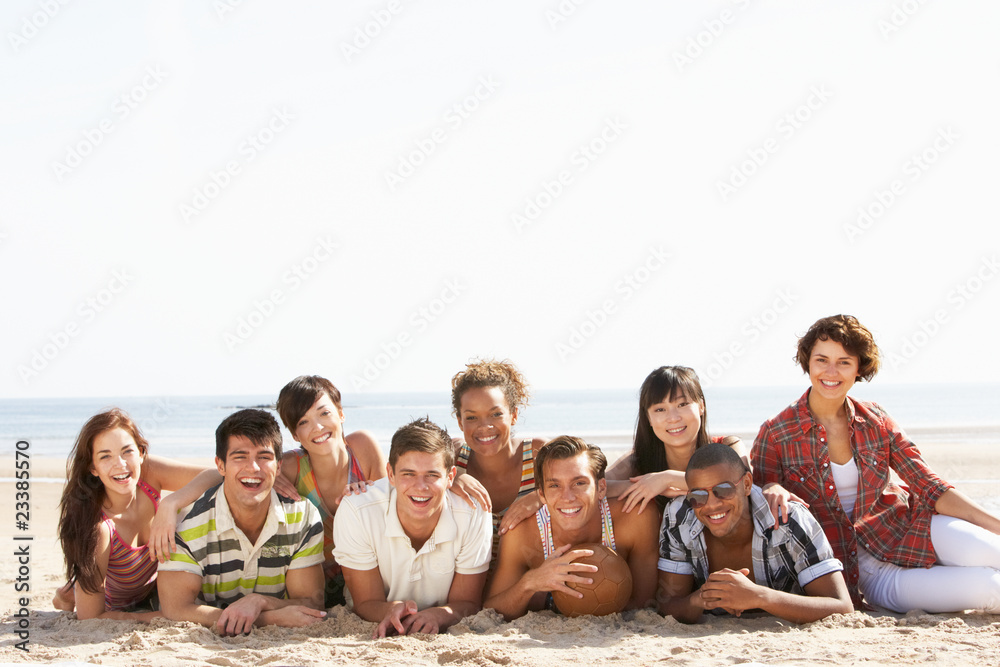 Group Of Friends Sitting On Beach Together Group Of Friends Sitting On Beach Together