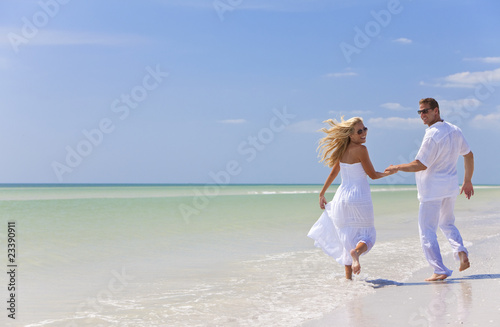 Happy Young Couple Running Holding Hands on A Tropical Beach