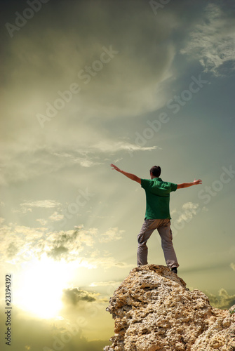 Man on peak of mountain