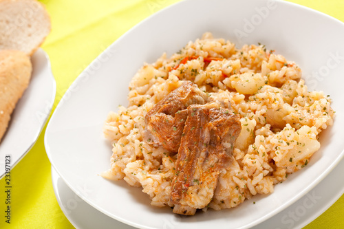 rice dish with potatoes and pork chops