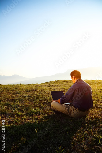 Freedom - Man using a laptop outdoors with copyspace