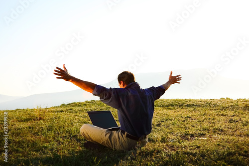 Freedom - Man using a laptop outdoors with copyspace