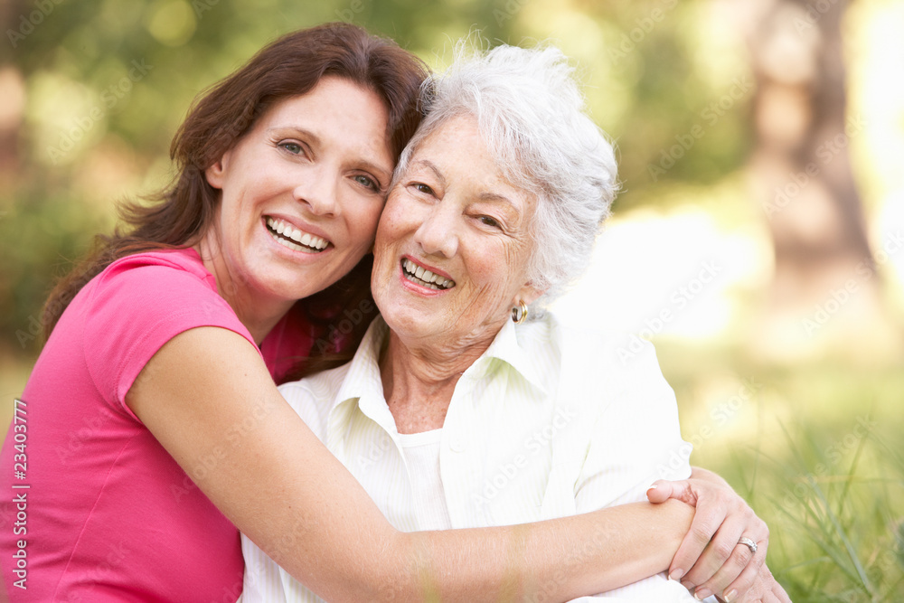 Senior Woman With Adult Daughter In Park Senior Woman With Adult Daughter In Park
