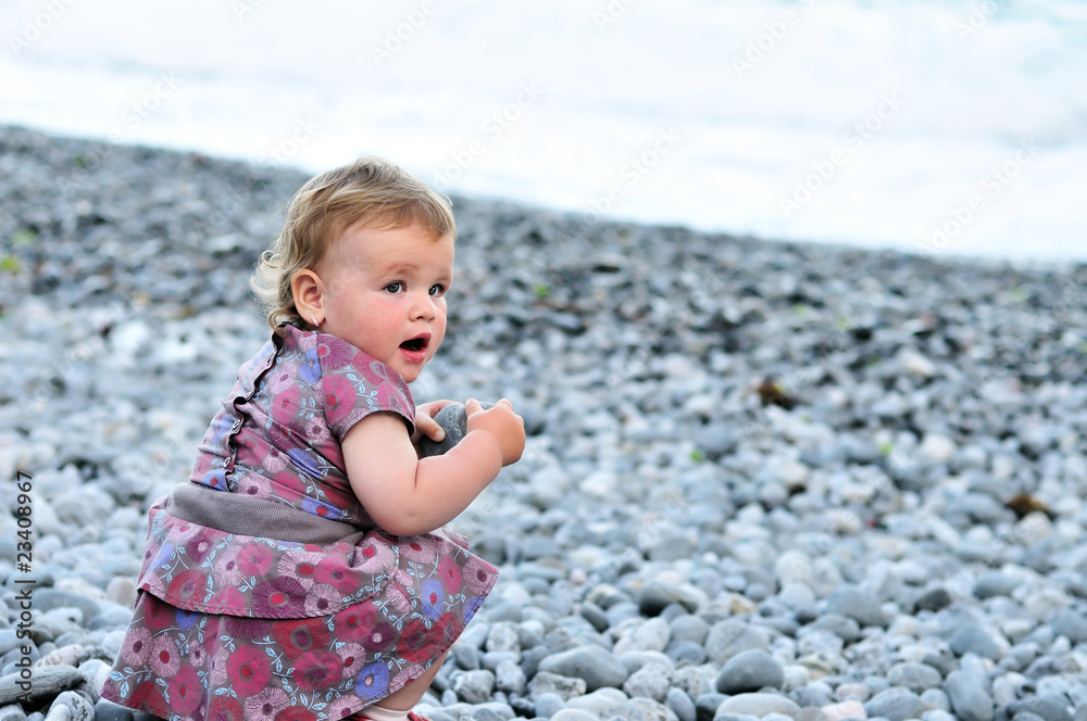baby with pebble