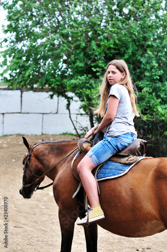 teen girl riding horse