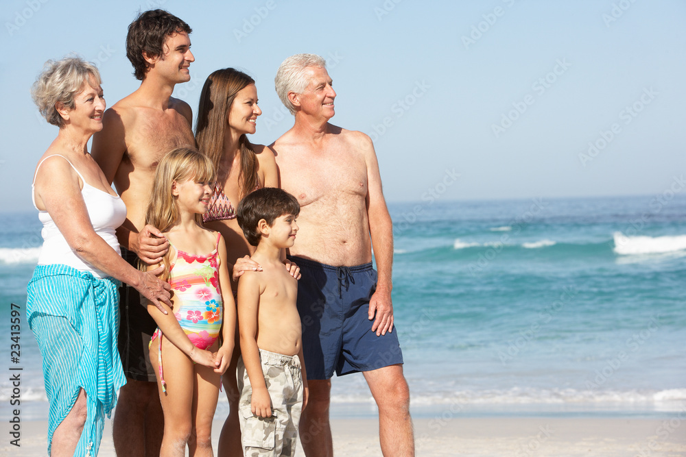 Three Generation Family On Holiday Walking Along Beach Three Generation Family On Holiday Walking Along Beach