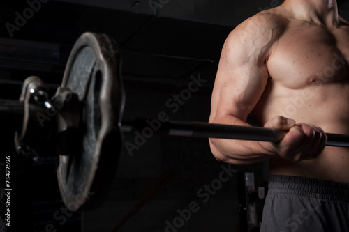 Shirtless guy lifting weights