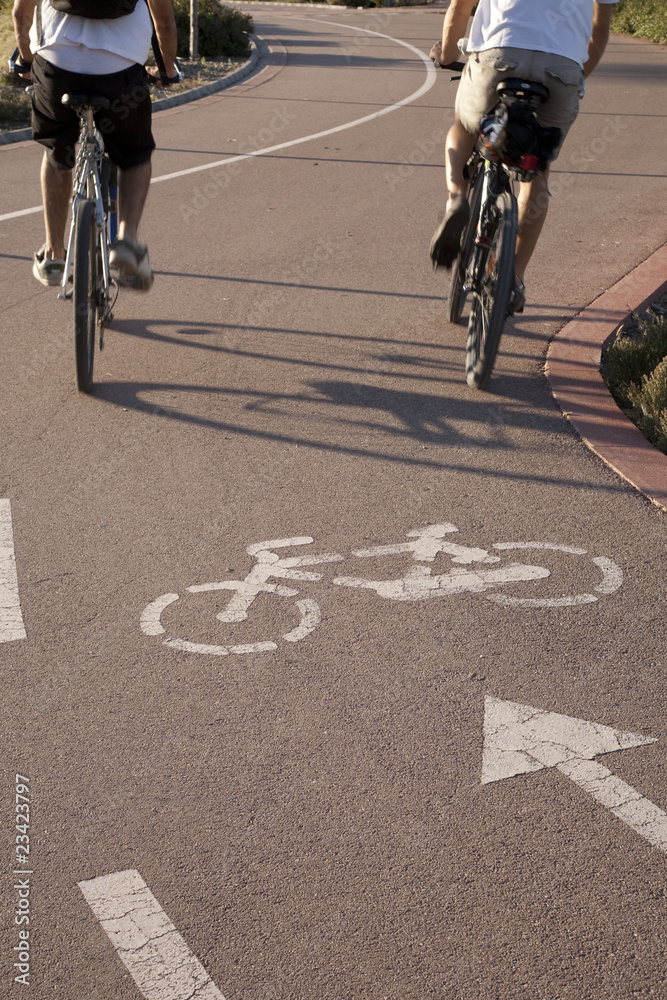 Two cyclists on bike lane keeping fit