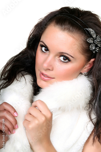 Young seductive woman in white fur