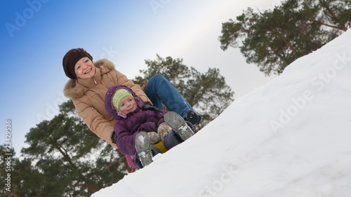 Woman with little girl in winter