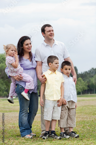 Happy family with three kids looking away with curiosity