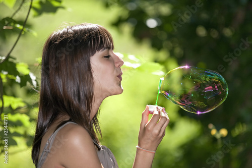teen blowing bubble