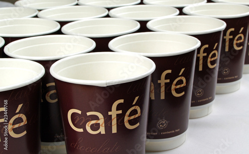 Row of cafe paper coffee cups photo