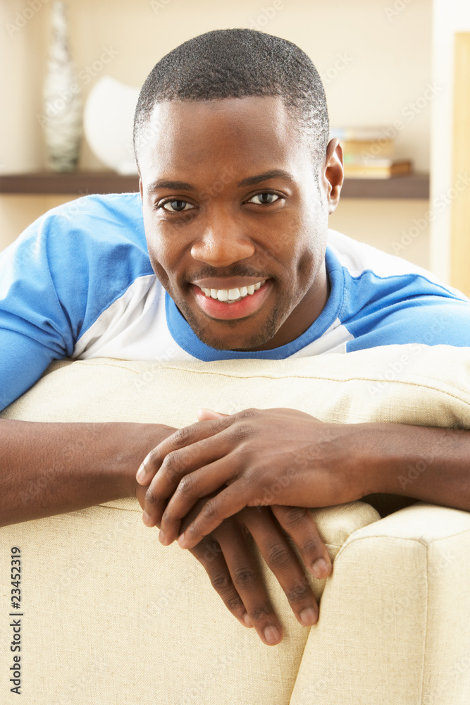 Man Relaxing On Sofa At Home Man Relaxing On Sofa At Home