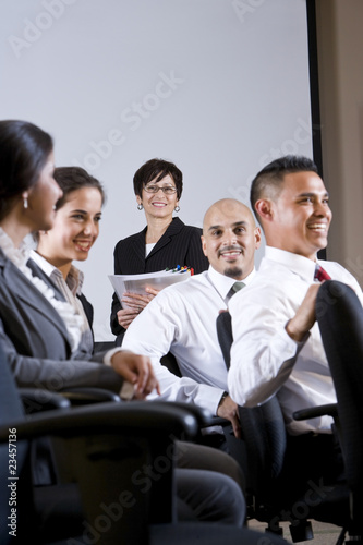 Diverse group businesspeople watching presentation