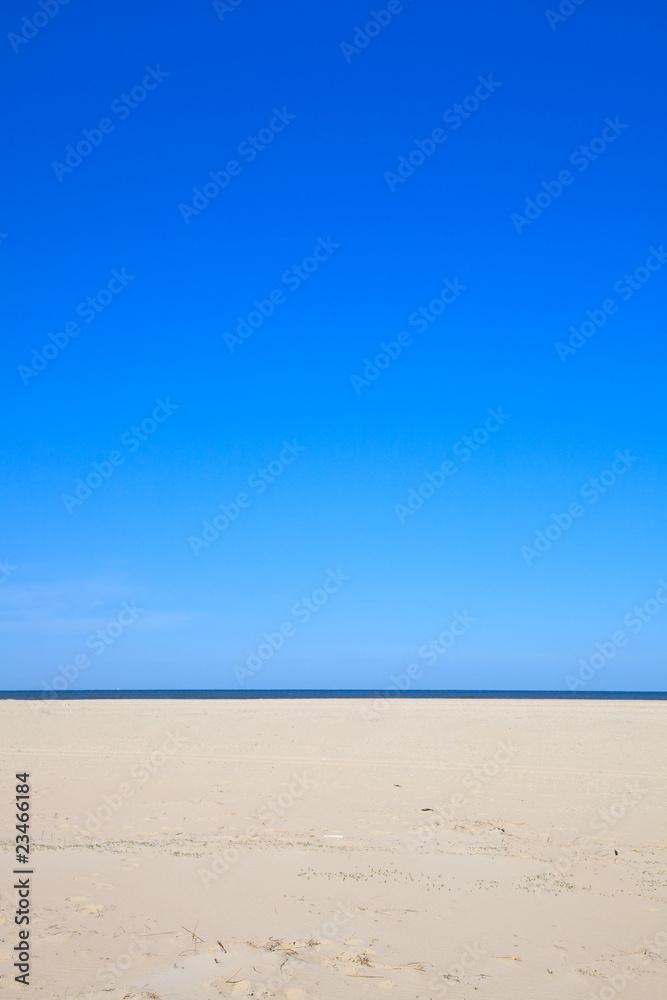 A blue clear sky with beach and ocean