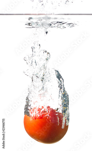 tomato splashing into water isolated on white background