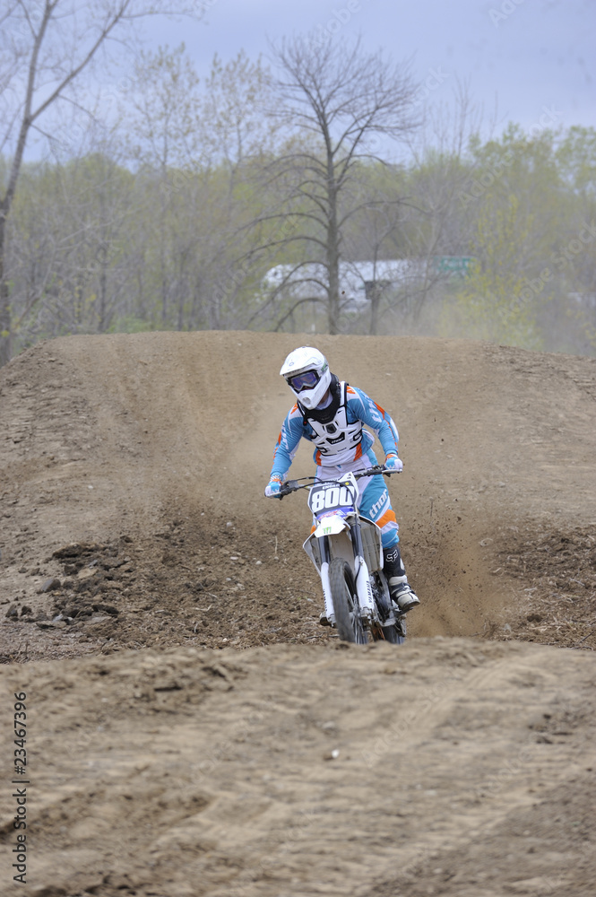 Motocross Racer Riding Down a Dirt Hill Motocross Racer Riding Down a Dirt Hill