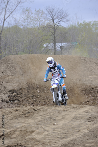 Motocross Racer Riding Down a Dirt Hill